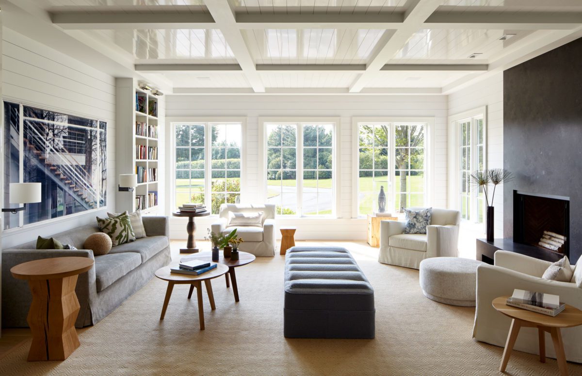 Bridgehampton Estate | Spacious Livingroom in Light Colors, Cozy Sofa and Chairs and Big Windows with Views of the Garden