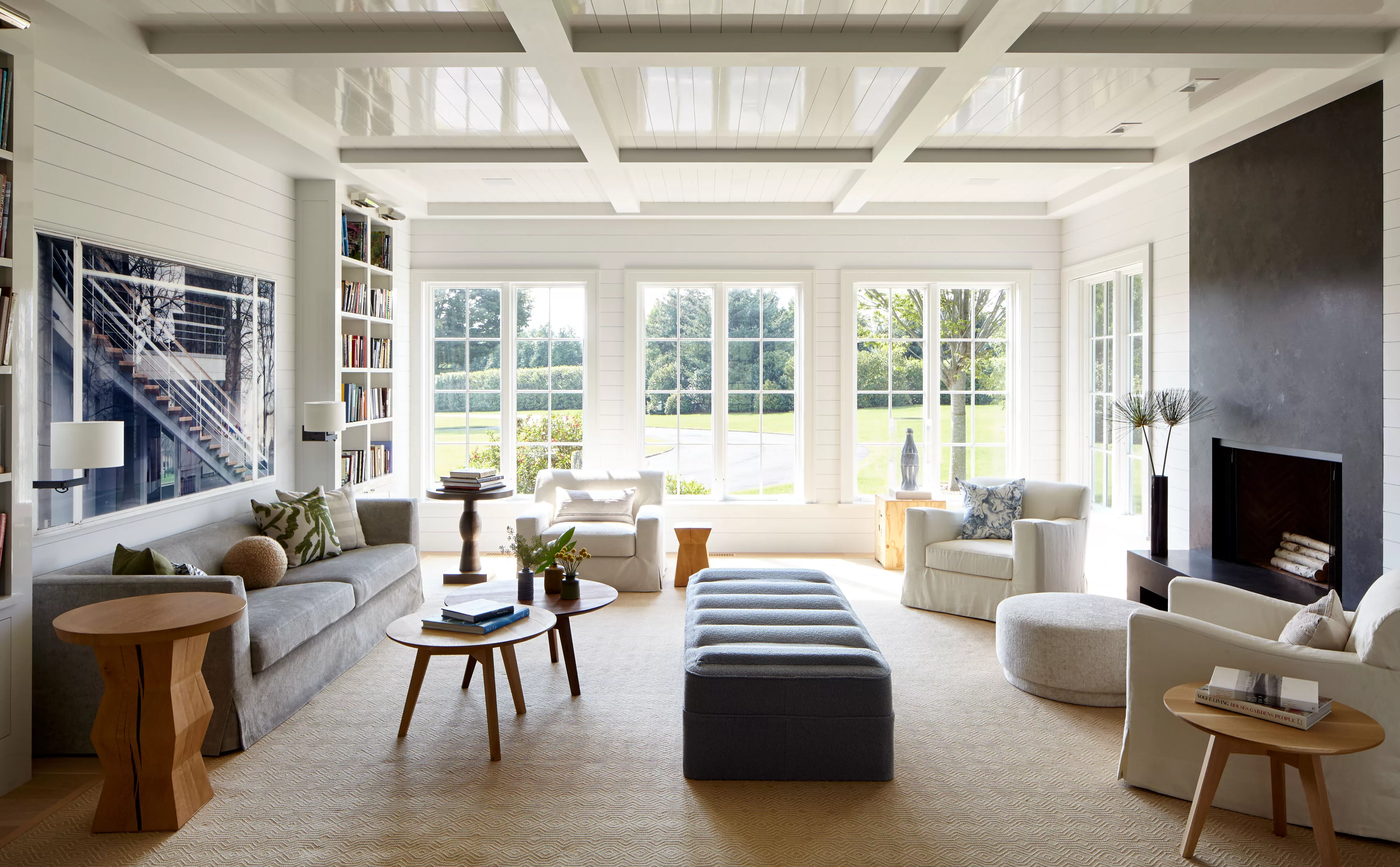 Bridgehampton Estate | Spacious Livingroom in Light Colors, Cozy Sofa and Chairs and Big Windows with Views of the Garden
