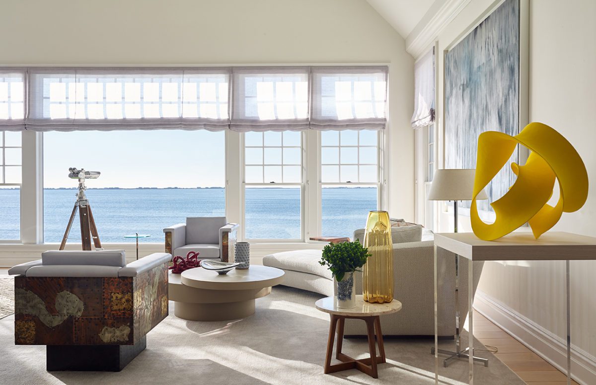 Waterfront Estate | Livingroom with White Cozy Furniture and Big Windows with Views of the Water