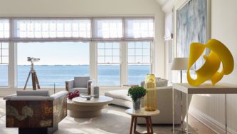 Waterfront Estate | Livingroom with White Cozy Furniture and Big Windows with Views of the Water