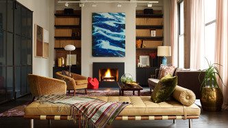 Iacono Residence | Cozy livingroom With Comfortable Furniture in Brown Tones and a Fireplace at the Bottom