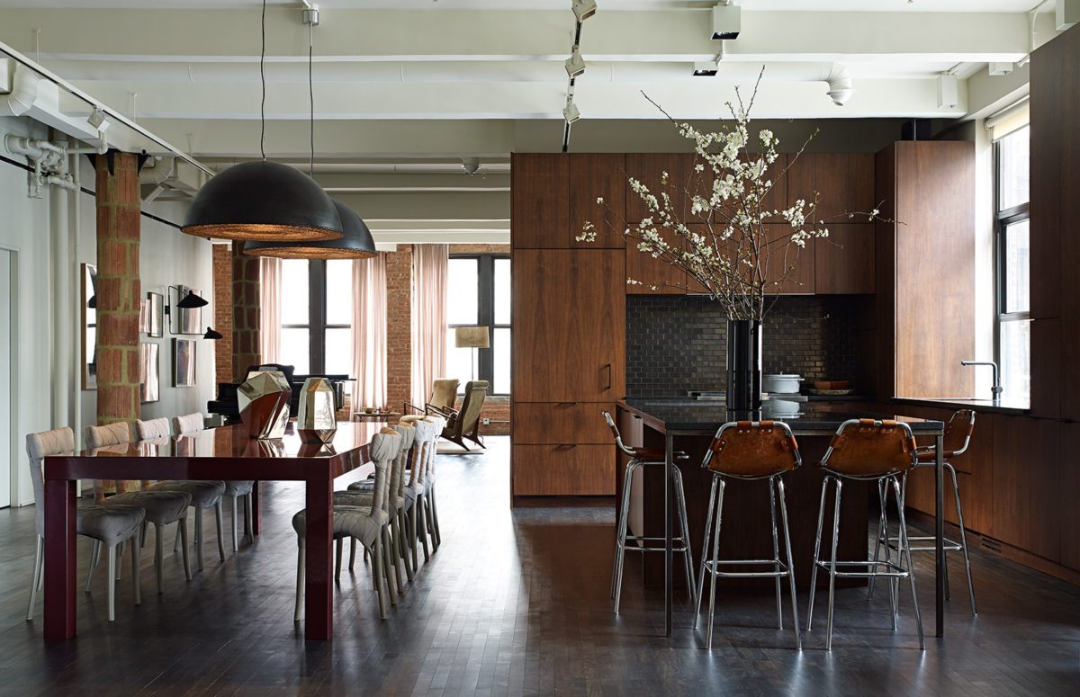 Spacious Kitchen With Dark Wooden Furniture and A Dining Table and A Kitchen Counter