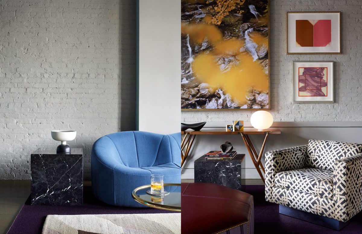 A Cube-Shaped Black Marble Table next to a Blue Sofa and a cozy Armchair