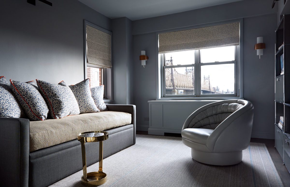 Seating area with monochrome cushions and wall and window