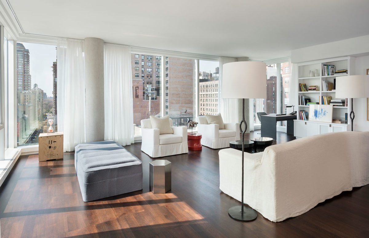 Spacious Living Room with White Sofa and Armchairs and Views of the City