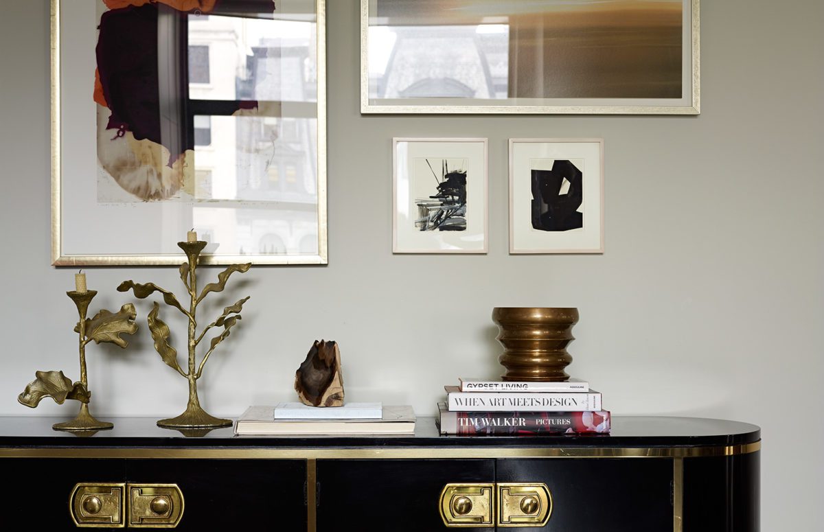 Black Cabinets with Golden Elements with Decorations and Books on top