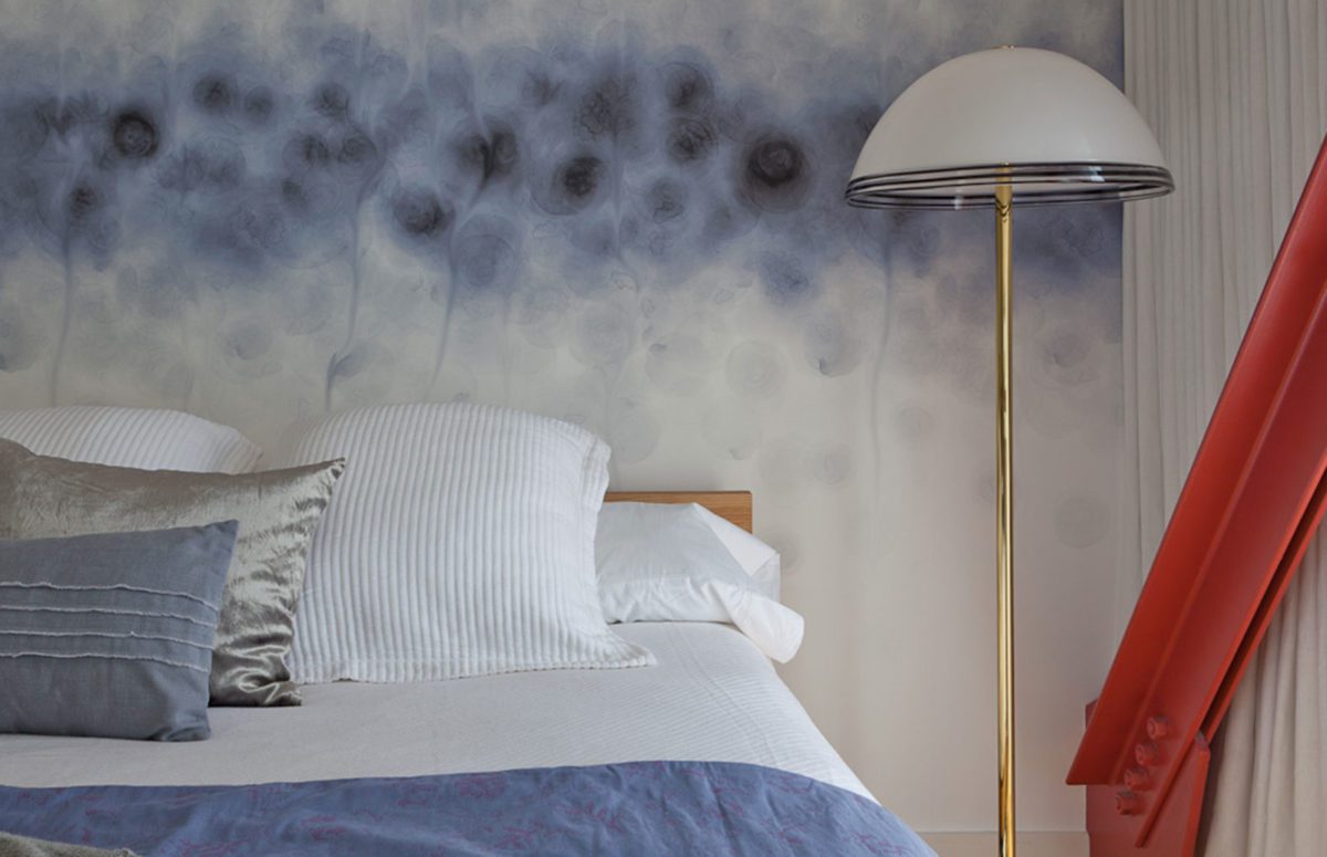 Bedroom in Venice Loft view of bed and lamp in white and blue hues