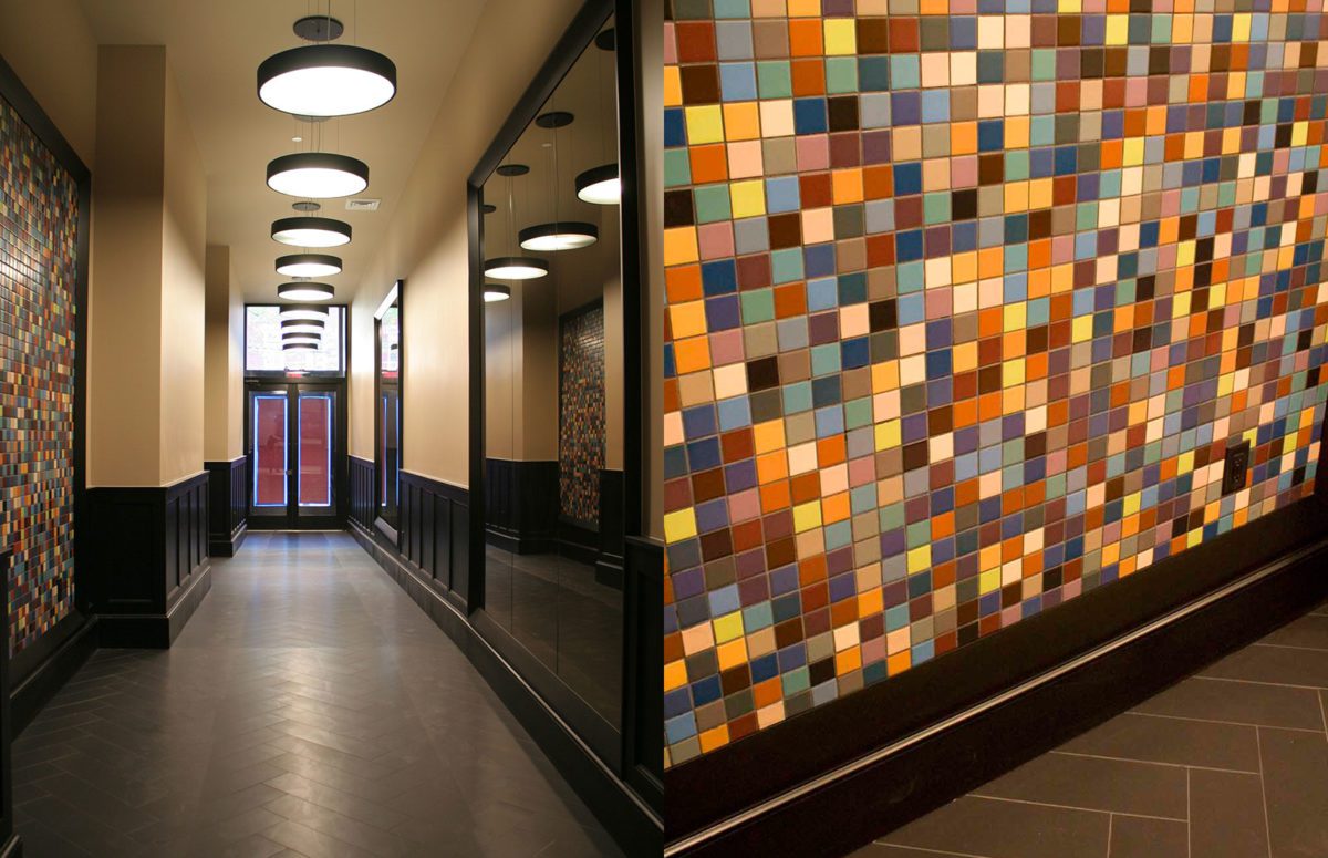 A Corridor with a Wall Covered by small square-shaped tiles in different colors