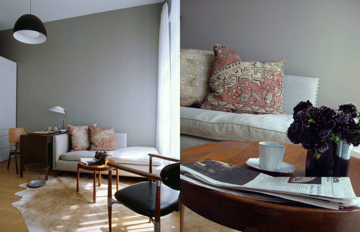 Sitting Area with A Short White Sofa, a black leather chair and a small wooden round table over a Black Bear Carpet