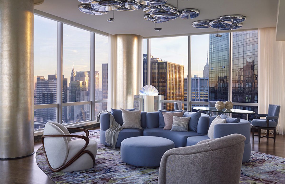 ONE57 Apartment | Livingroom of blue hues and view of the NYC skyline