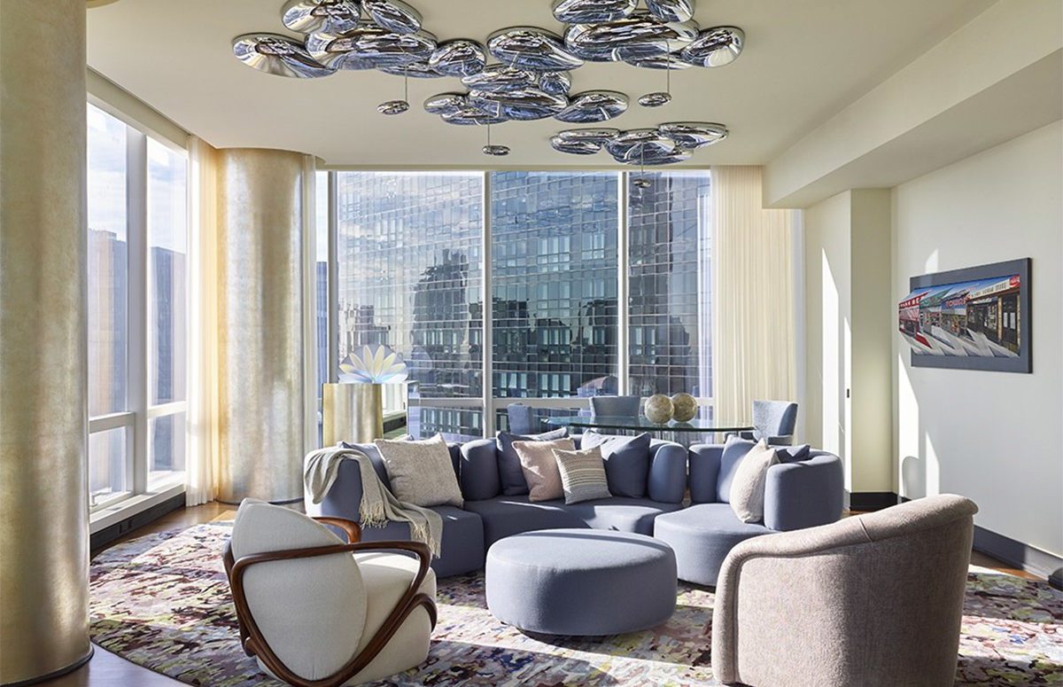 Illuminated Living room with blue sofa and impressive views of the city