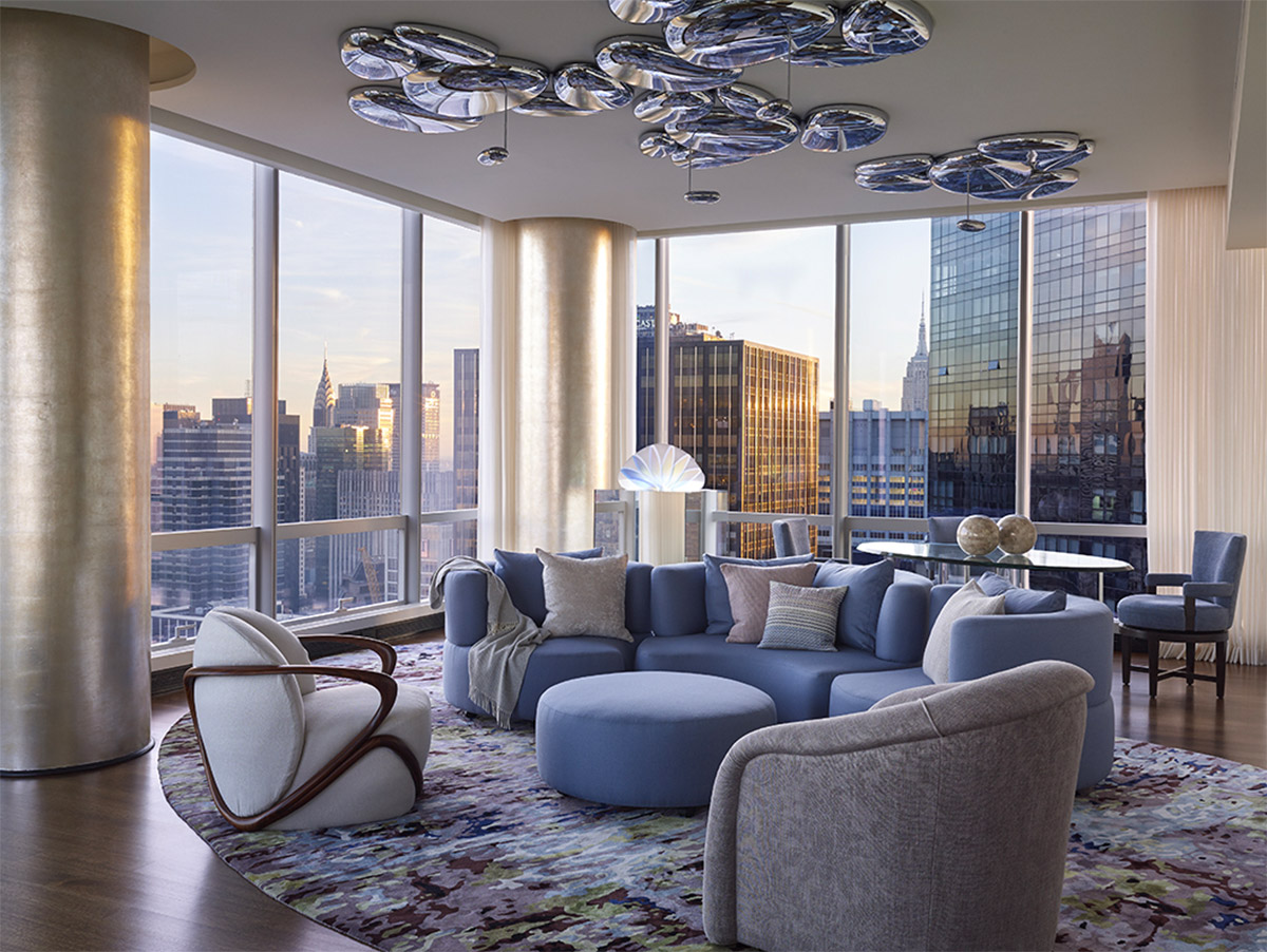 ONE57 Apartment | Livingroom of blue hues and view of the NYC skyline