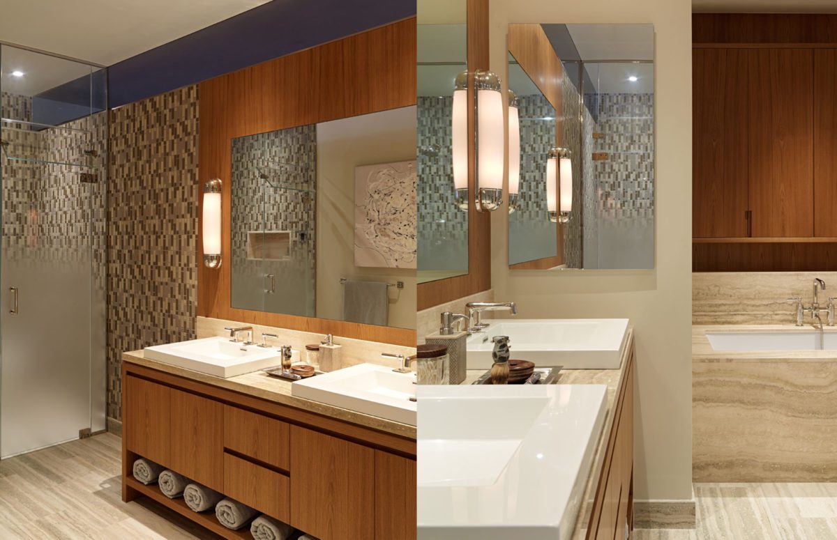 Bathroom in Warm Colors with Wooden Cabinets and Marble Bathtub.