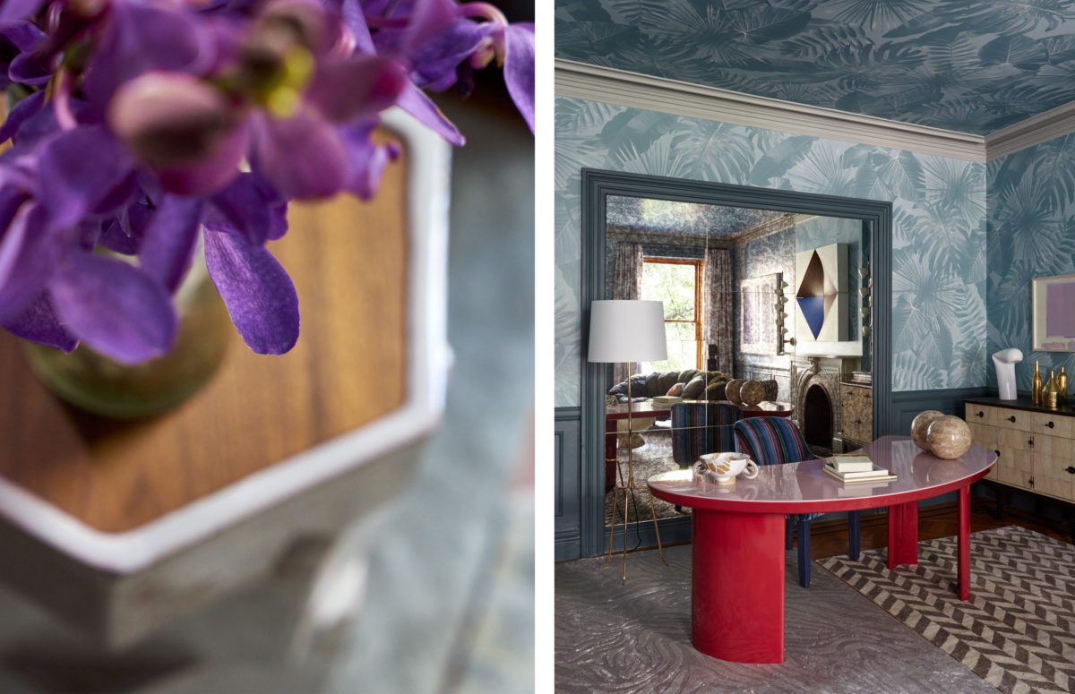 Top view of a Lilac Flower. Workspace with a large red desk by Big Mirror Panels and blue wallpaper.