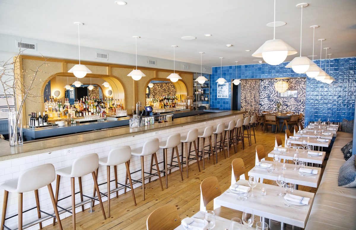 Rosie's Restaurant | Blue, white, and beige Interior Design, Large Bar Counter and A Dining Area to the Right.