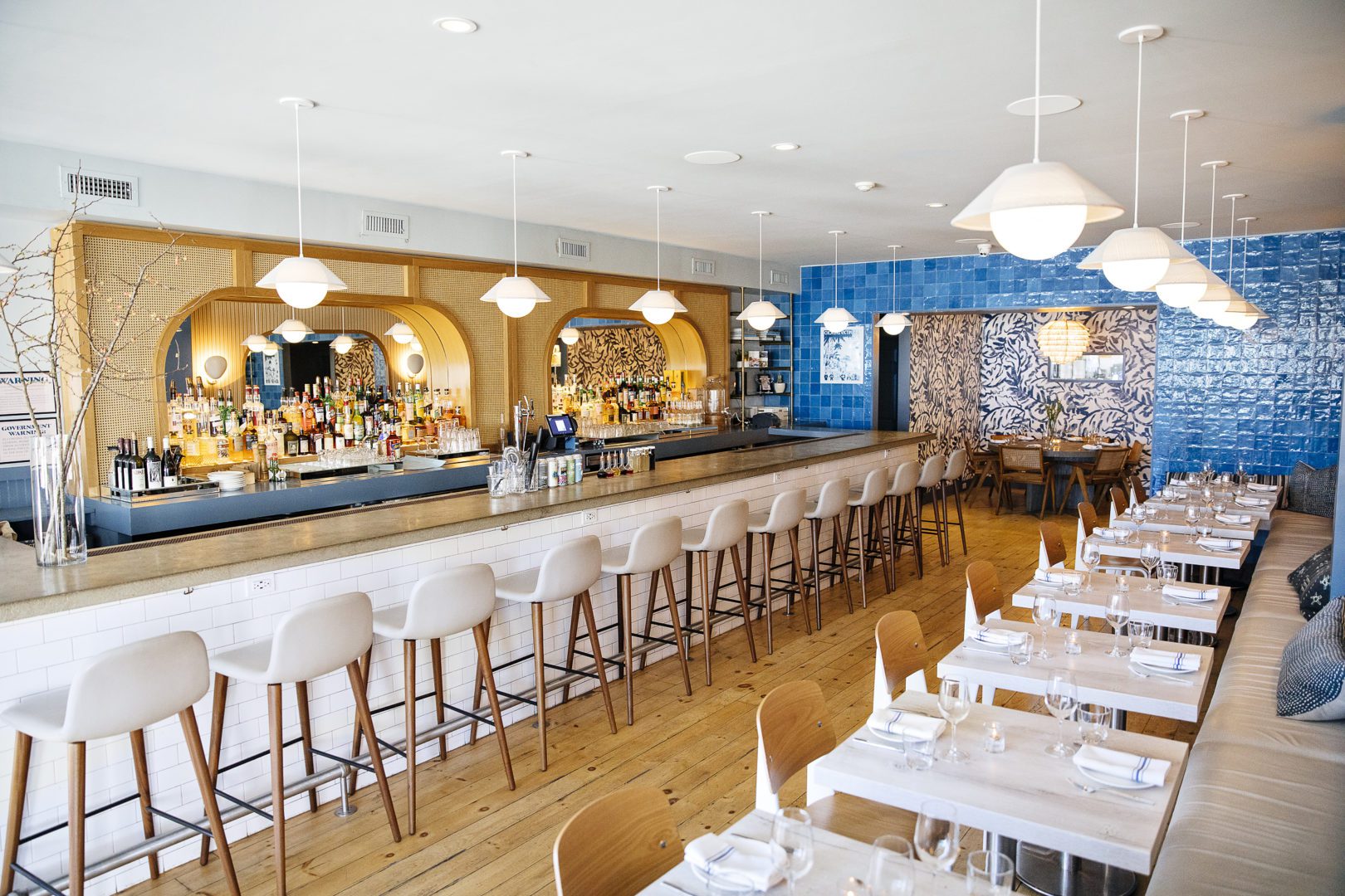 Rosie's Restaurant | Blue, white, and beige Interior Design, Large Bar Counter and A Dining Area to the Right.