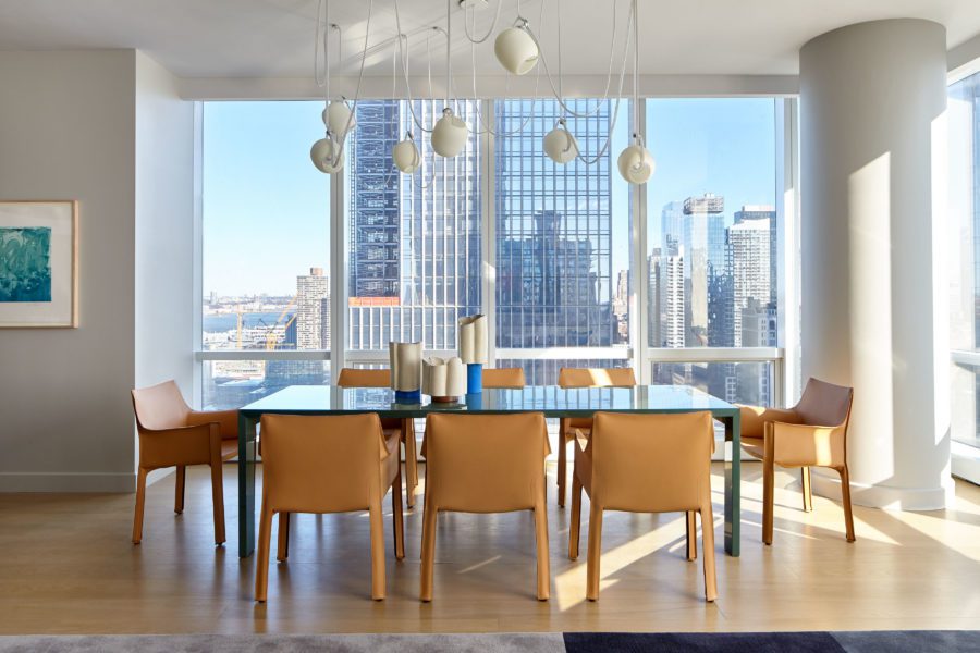 Dining Room with Large Dining Table, Leather Chairs and Huge Windows with Views of a Skyscraper