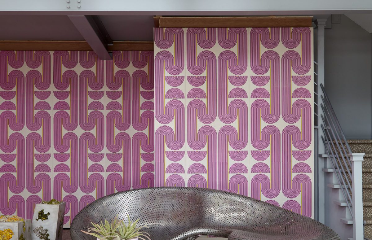 View of Living Room With Pink Wallpaper and Grey Metallic Sofa