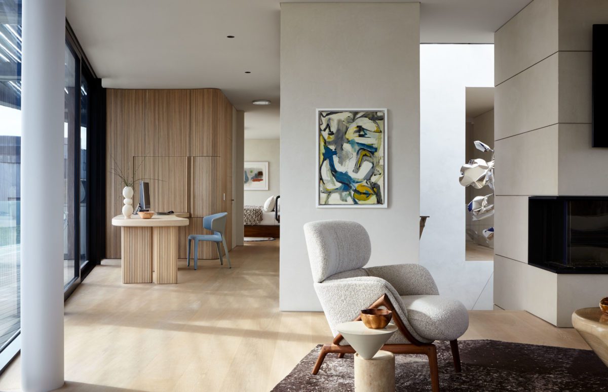 Spacious Corridor with A Working Area and A White Reading Arm Chair