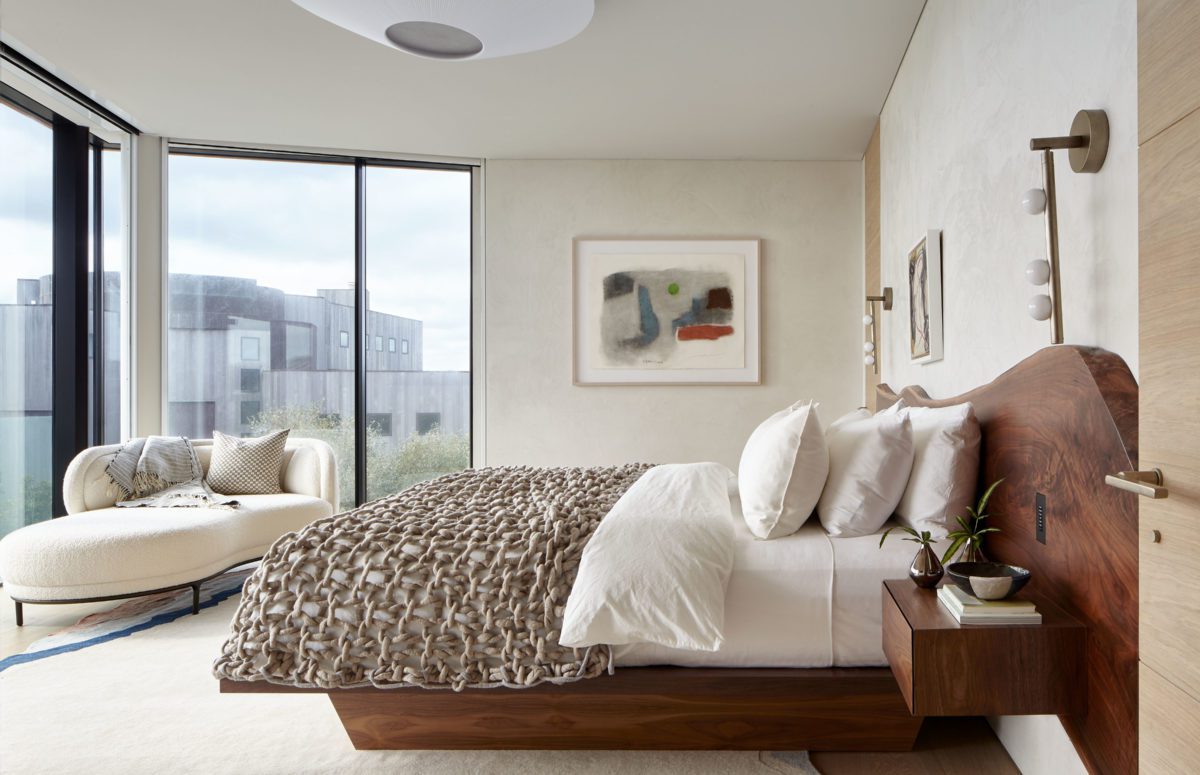 View of a bedroom with floor-to-ceiling windows and lounge chaise