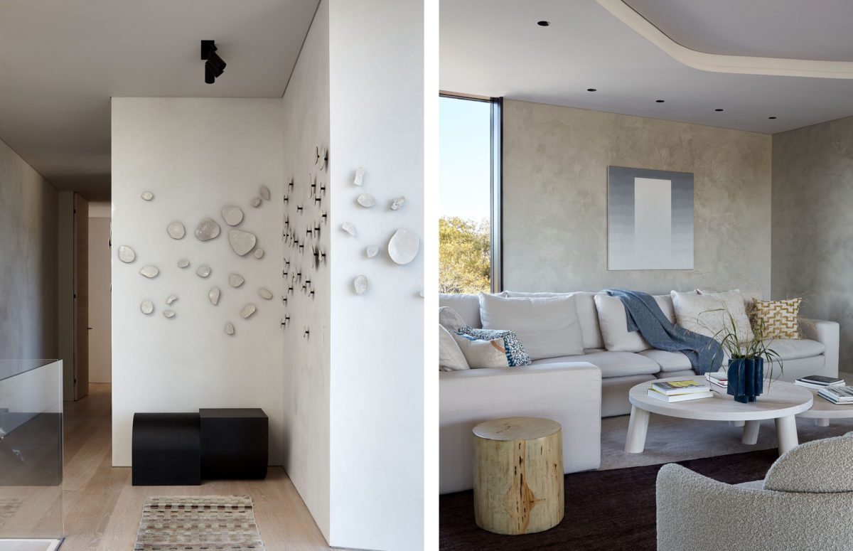 White Corridor with Multiple Decorative Elements on the Wall and A View of a Living Room