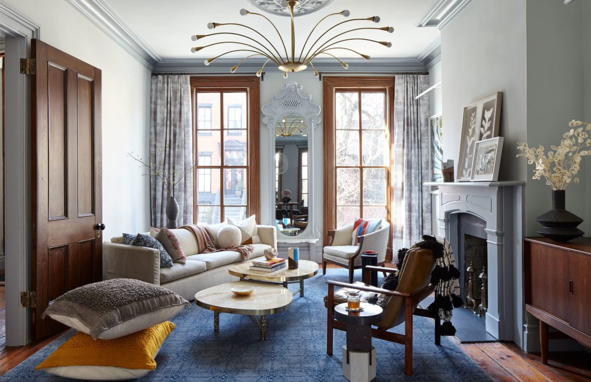 Brooklyn Townhouse | Living Room with White Cozy Sofa and Two Wooden Chairs next to the Fireplace