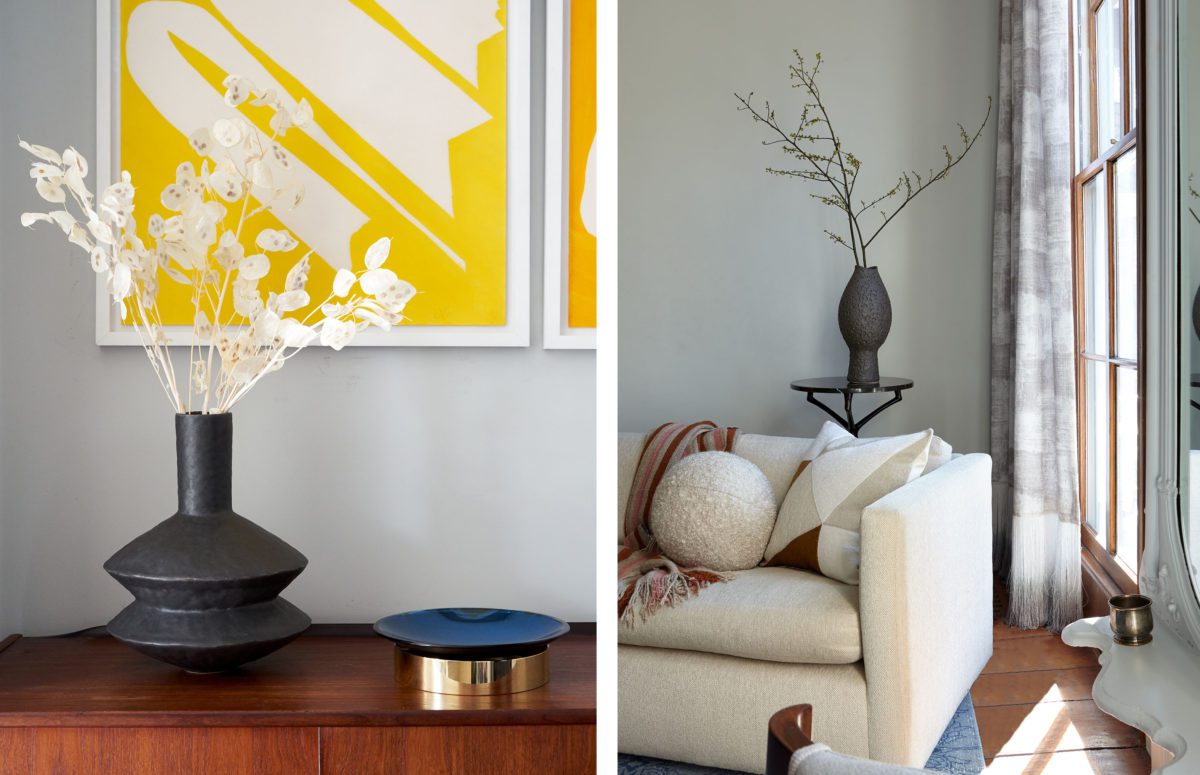 Black Vase with White Decorative Flowers on a Wooden Cabinet and a White Tux Sofa