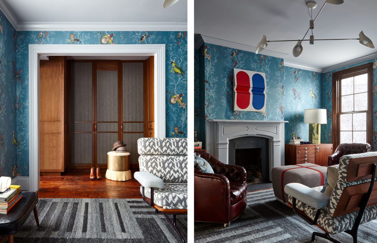 View of a room with Big Wooden Wardrope, Blue Wallpaper with birds and brown cozy chairs next to a fireplace.