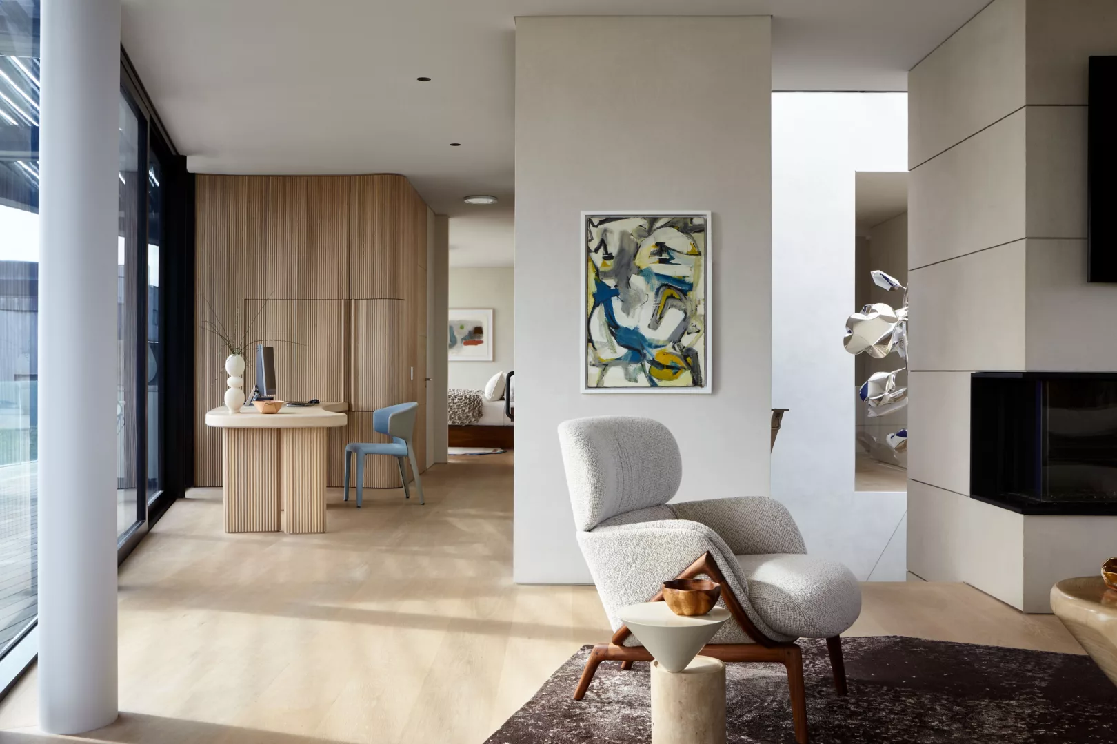 Spacious Corridor with A Working Area and A White Reading Arm Chair