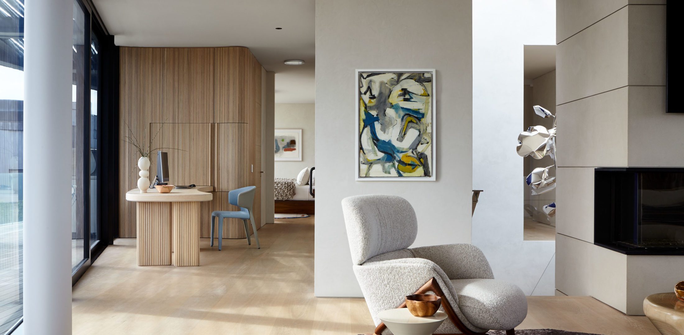 Spacious Corridor with A Working Area and A White Reading Arm Chair