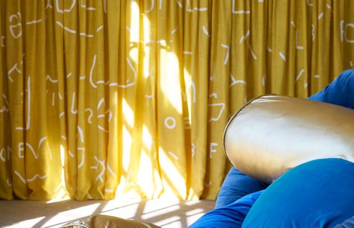 Exhibition The Barn, Zoomed-in View of a Blue and Golden Noodle Pillow, and Yellow Curtains