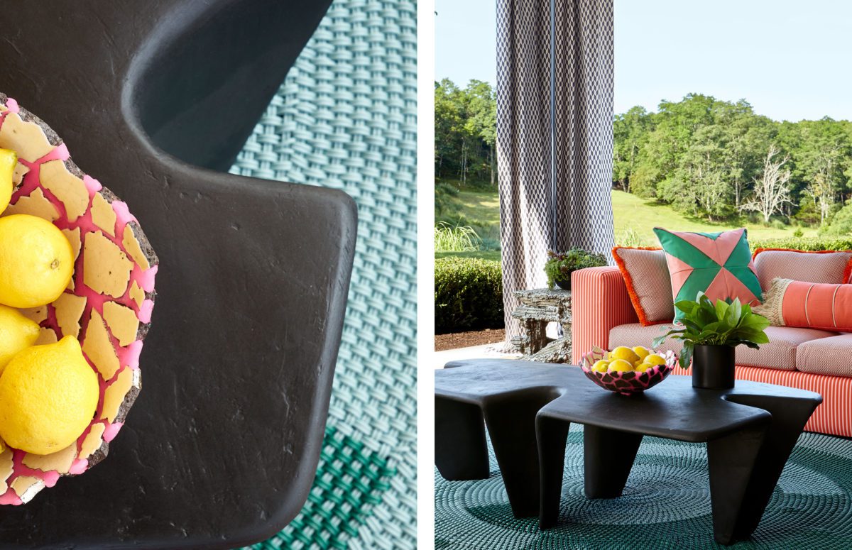 Outdoor lounge with an orange sofa and small black sculptural table