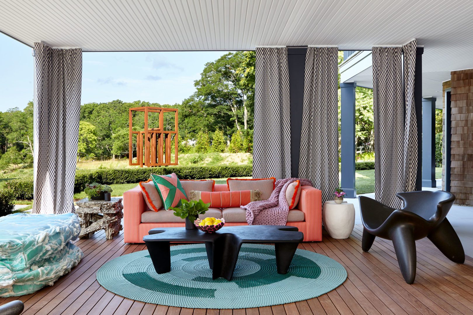 Galerie House of Art and Design | Sunset Terrace in the Garden with Cozy Orange Sofa and Sculptural Chairs