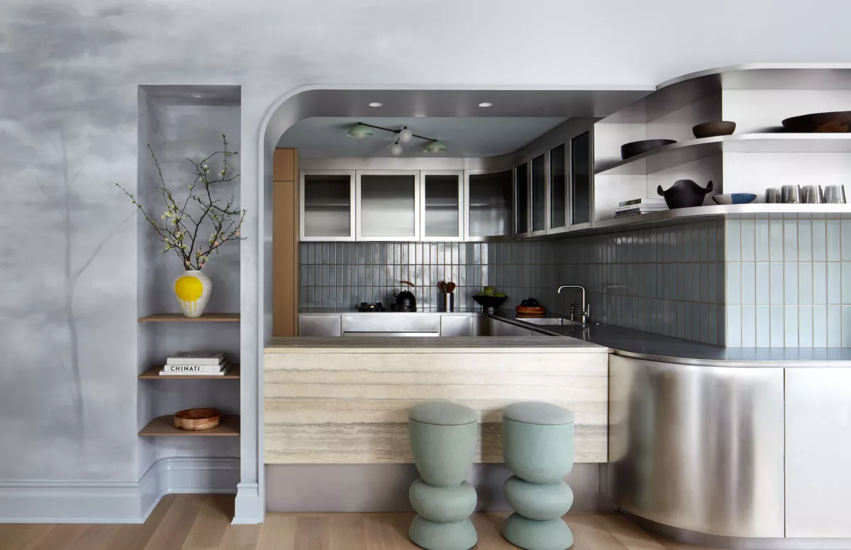 Modern steel kitchen with travertine counter and custom painted mural wall