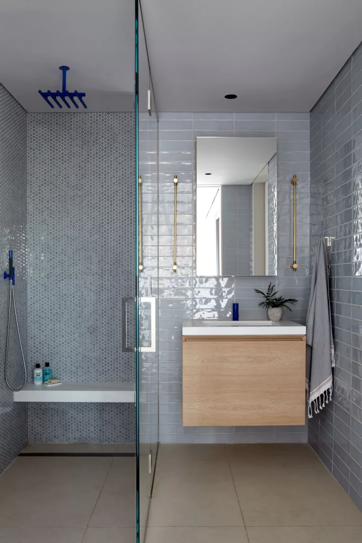 Bolder color in the secondary bath: powder blue tile and cobalt fixtures